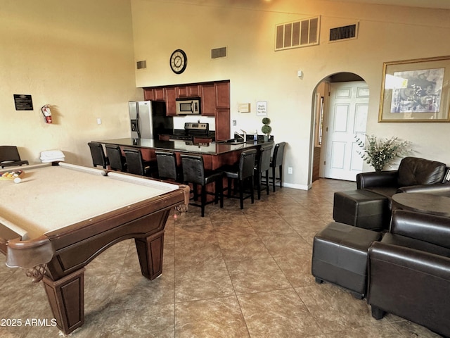 3825 E Camelback Rd Unit 152, Phoenix, AZ 85018 - playroom featuring arched walkways, high vaulted ceiling, a sink, billiards, and baseboards