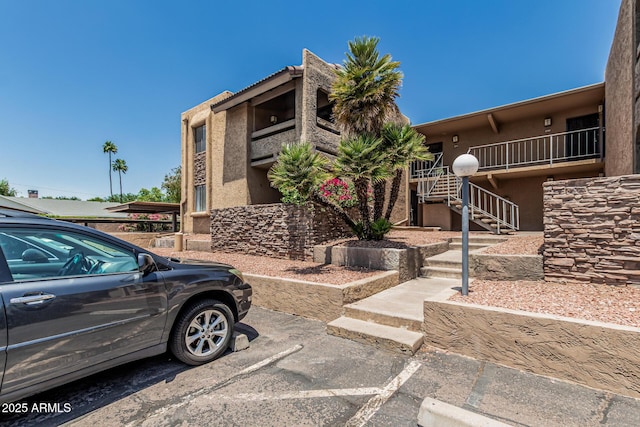 3825 E Camelback Rd Unit 152, Phoenix, AZ 85018 - view of property with stairs and uncovered parking