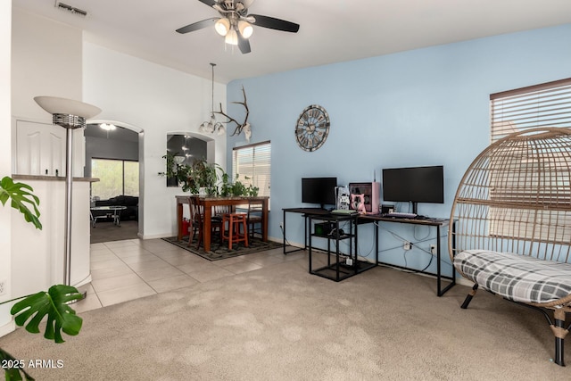tiled home office featuring a wealth of natural light, a ceiling fan, visible vents, and carpet flooring
