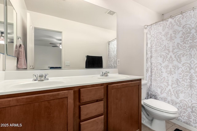 full bath featuring a sink, double vanity, toilet, and tile patterned flooring