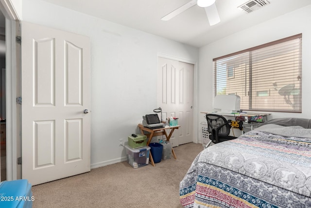 carpeted bedroom with baseboards, ceiling fan, a closet, and visible vents