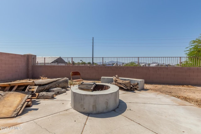 view of patio with a fenced backyard and an outdoor fire pit