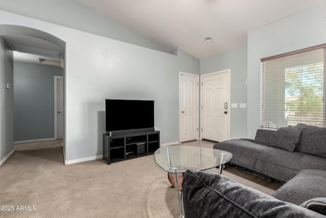 living room with lofted ceiling, carpet flooring, and baseboards
