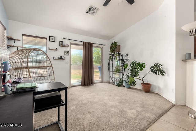 interior space featuring lofted ceiling, visible vents, ceiling fan, tile patterned flooring, and carpet flooring