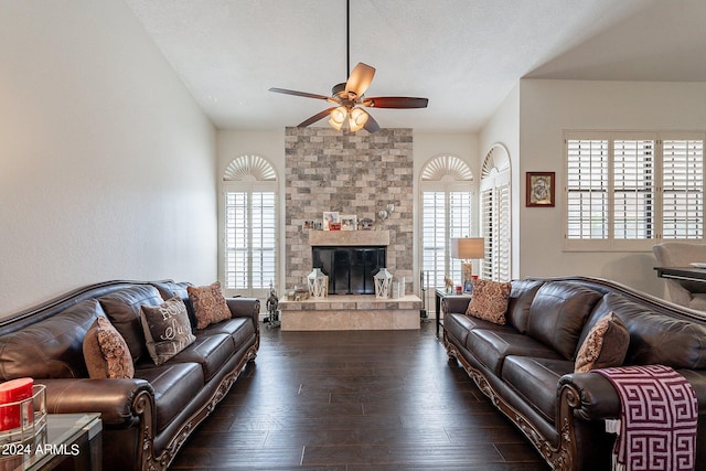 living room with a fireplace, ceiling fan, a textured ceiling, and dark hardwood / wood-style floors