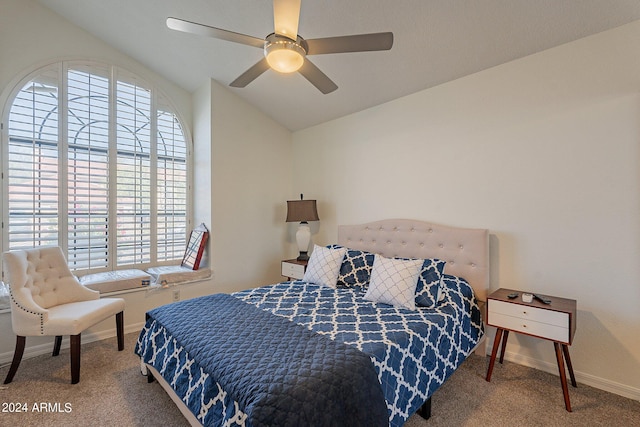 carpeted bedroom featuring ceiling fan and vaulted ceiling