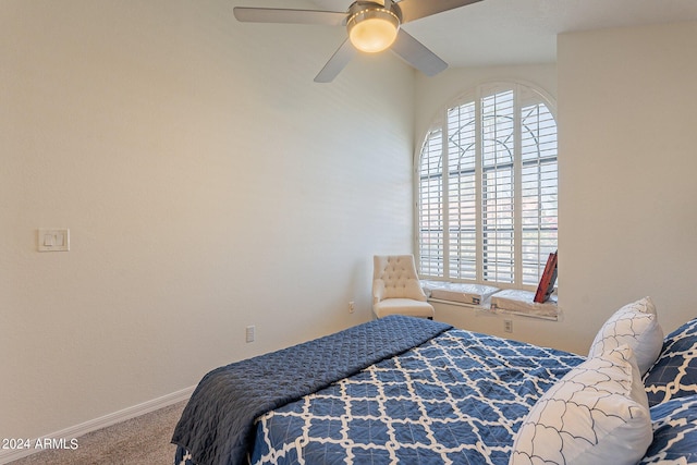 carpeted bedroom featuring multiple windows and ceiling fan