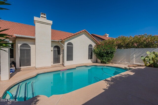 rear view of property featuring a yard and a patio