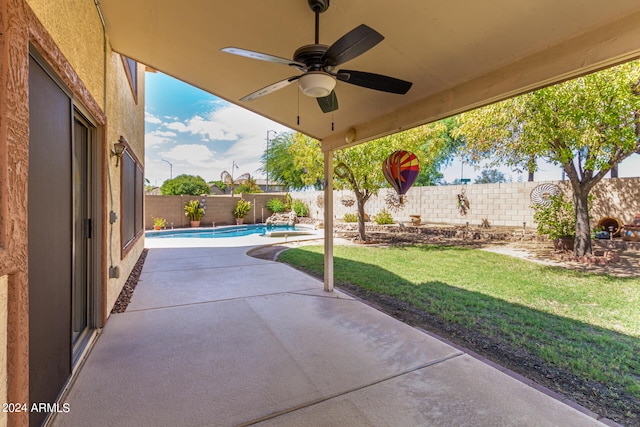 view of patio / terrace featuring ceiling fan and a fenced in pool