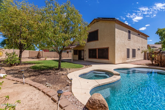 view of swimming pool with a patio area and an in ground hot tub