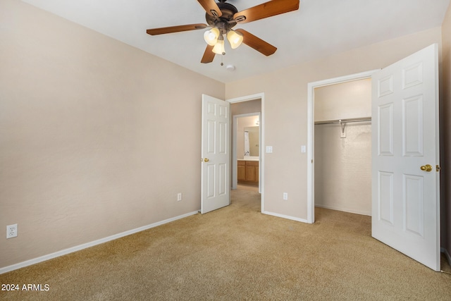 unfurnished bedroom featuring ceiling fan, a closet, and light carpet