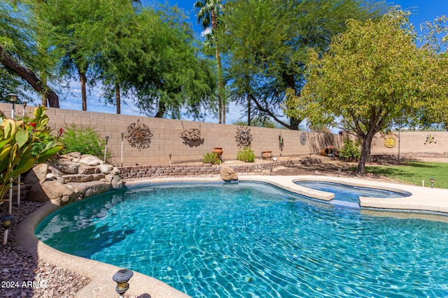 view of pool with an in ground hot tub