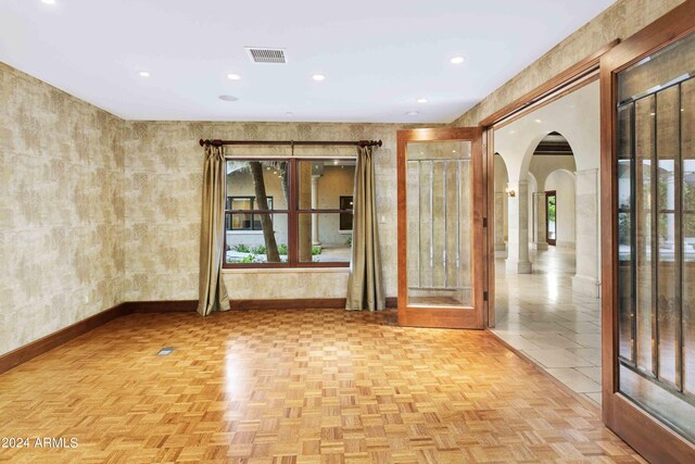 doorway to outside with light tile patterned floors, crown molding, and french doors