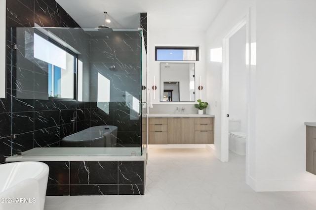 full bathroom with shower with separate bathtub, vanity, toilet, and a healthy amount of sunlight