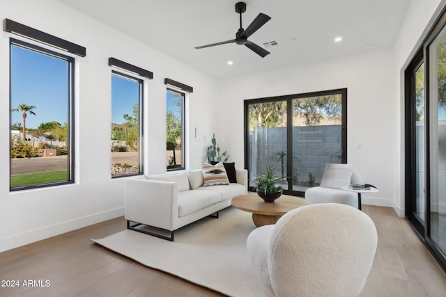 living room featuring ceiling fan and light wood-type flooring