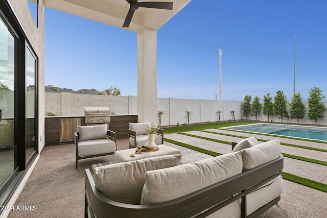 view of patio / terrace with a fenced in pool, area for grilling, and ceiling fan