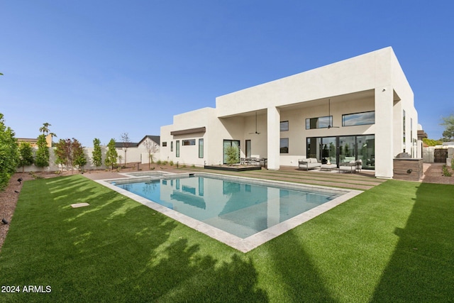 rear view of house featuring a yard, an outdoor living space, and a patio