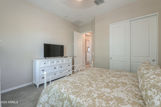 carpeted bedroom featuring ceiling fan and a closet