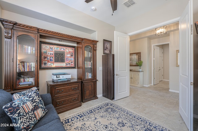 interior space with ceiling fan with notable chandelier