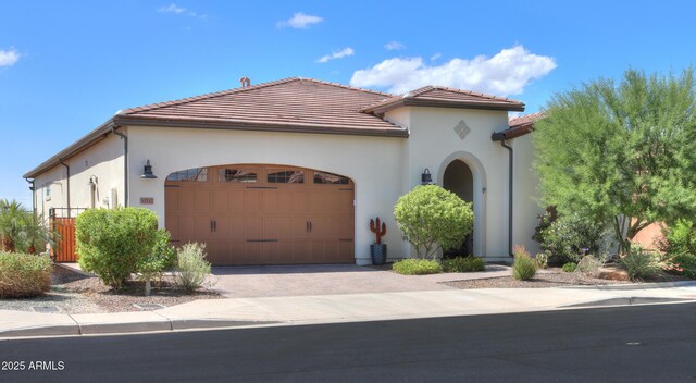 mediterranean / spanish home featuring a garage