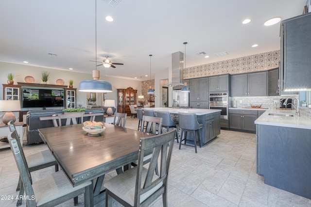 dining area with sink and ceiling fan