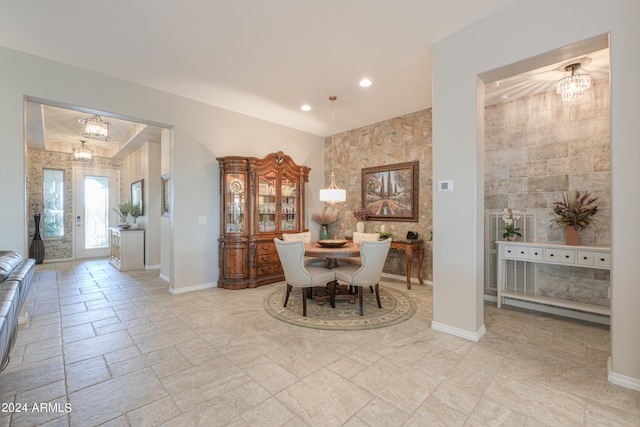 dining area with ornamental molding and an inviting chandelier