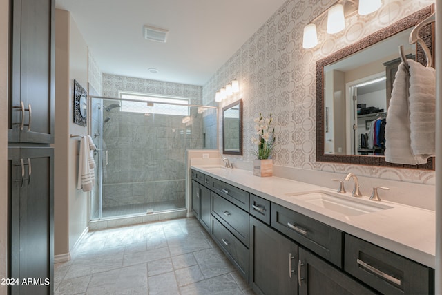 bathroom with a shower with door and vanity