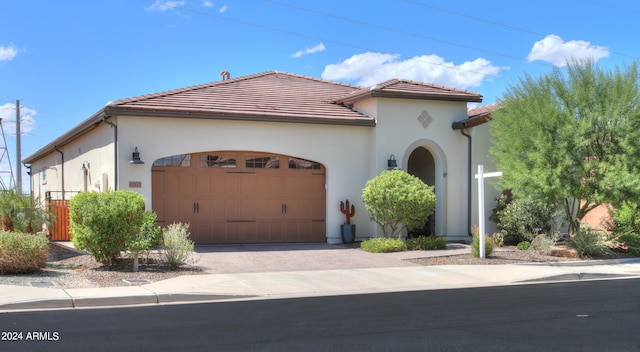 mediterranean / spanish-style home with a garage