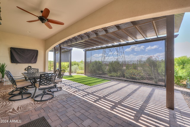 view of patio / terrace with ceiling fan and a pergola