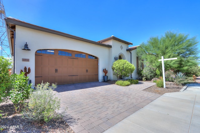 mediterranean / spanish home featuring a garage