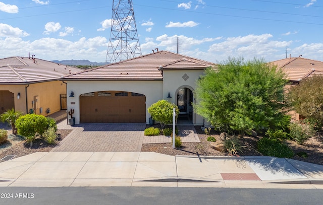 mediterranean / spanish-style house with a garage