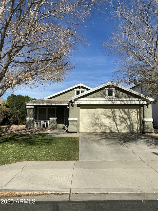 view of front of property with a front lawn, concrete driveway, covered porch, stucco siding, and an attached garage