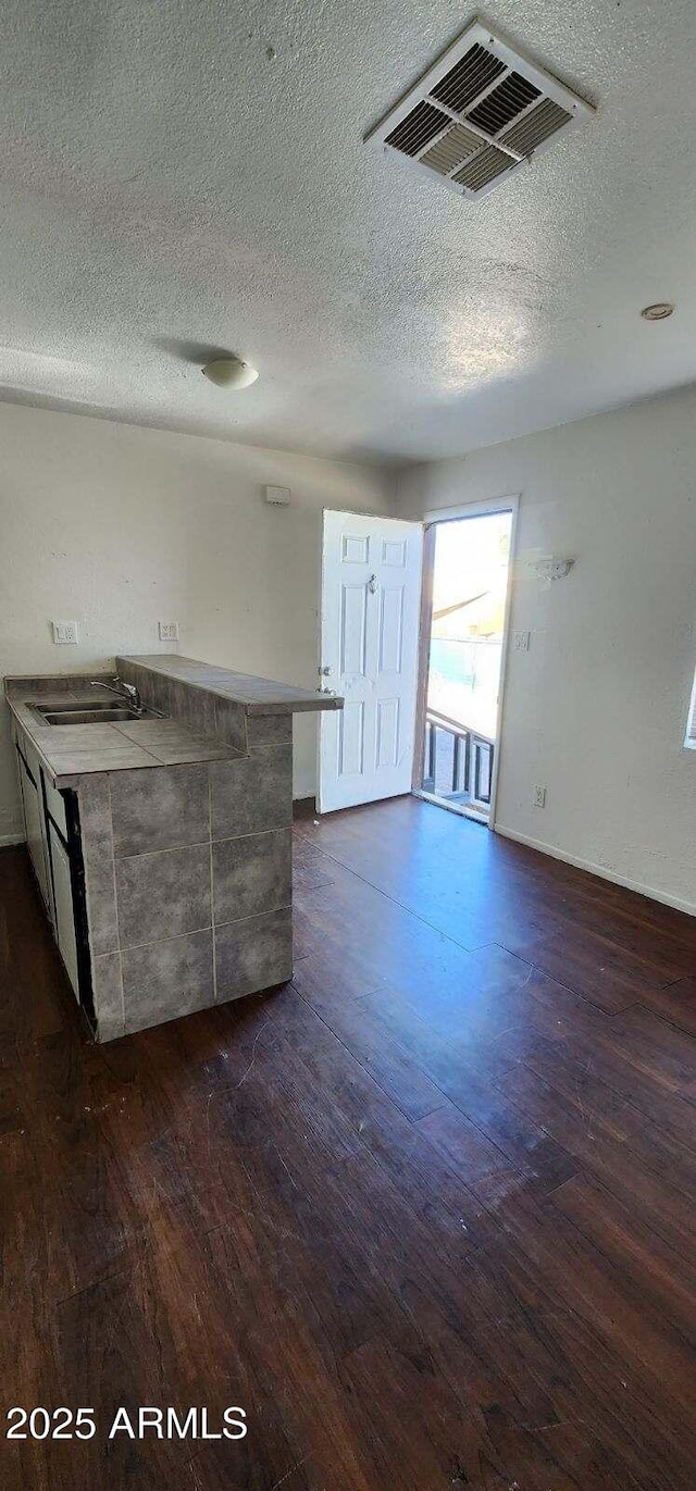 417 N 18th Dr, Phoenix, AZ 85007 - unfurnished living room with a sink, dark wood finished floors, and a textured ceiling