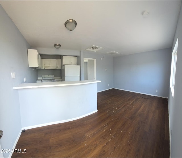417 N 18th Dr, Phoenix, AZ 85007 - kitchen with white appliances, light countertops, a peninsula, dark wood-style flooring, and baseboards