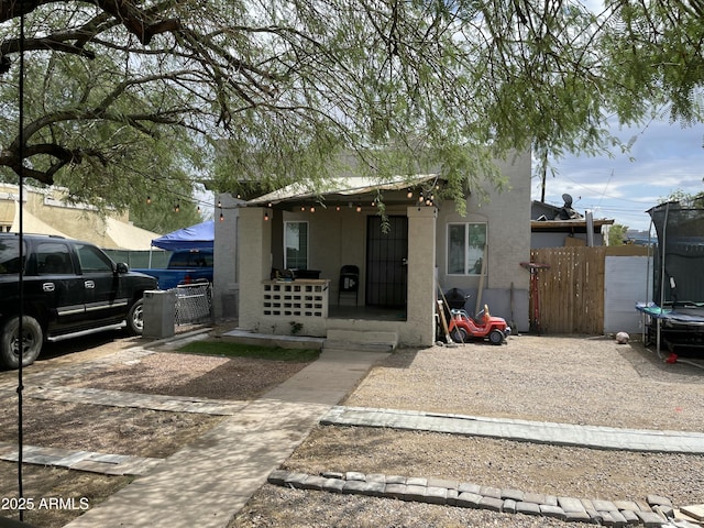 417 N 18th Dr, Phoenix, AZ 85007 - view of front of property with a trampoline, covered porch, and stucco siding