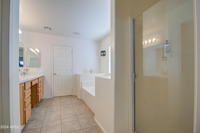 bathroom featuring tile patterned floors, independent shower and bath, and vanity