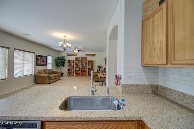 kitchen with light brown cabinetry, sink, tasteful backsplash, light hardwood / wood-style flooring, and dishwasher