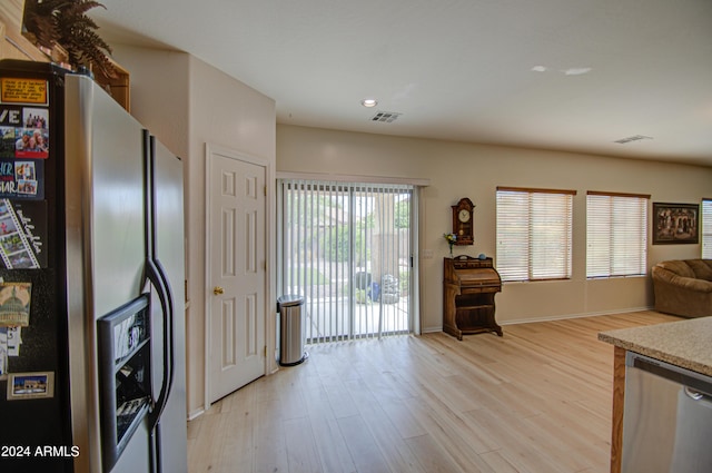 kitchen with light hardwood / wood-style flooring and appliances with stainless steel finishes