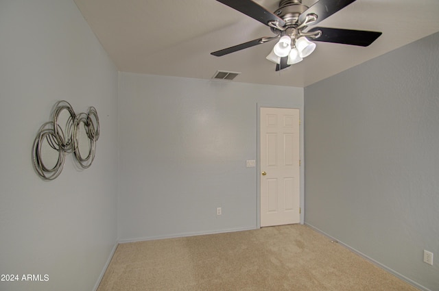 carpeted spare room with ceiling fan