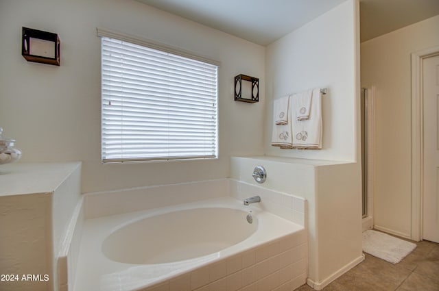 bathroom featuring tile patterned floors and separate shower and tub