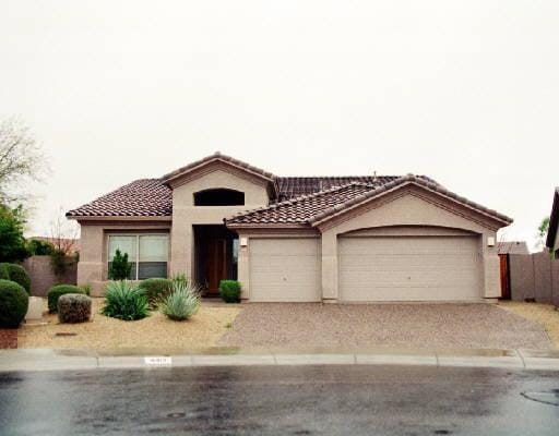 mediterranean / spanish-style home featuring a garage