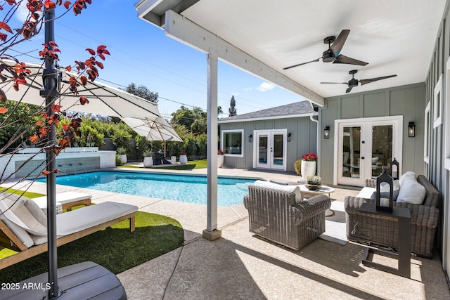 view of pool with a ceiling fan, french doors, a patio area, and a fenced in pool