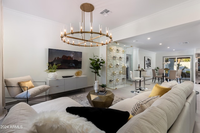 living room with an inviting chandelier and crown molding