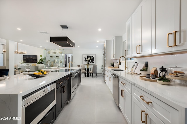 kitchen featuring white cabinetry and light stone counters