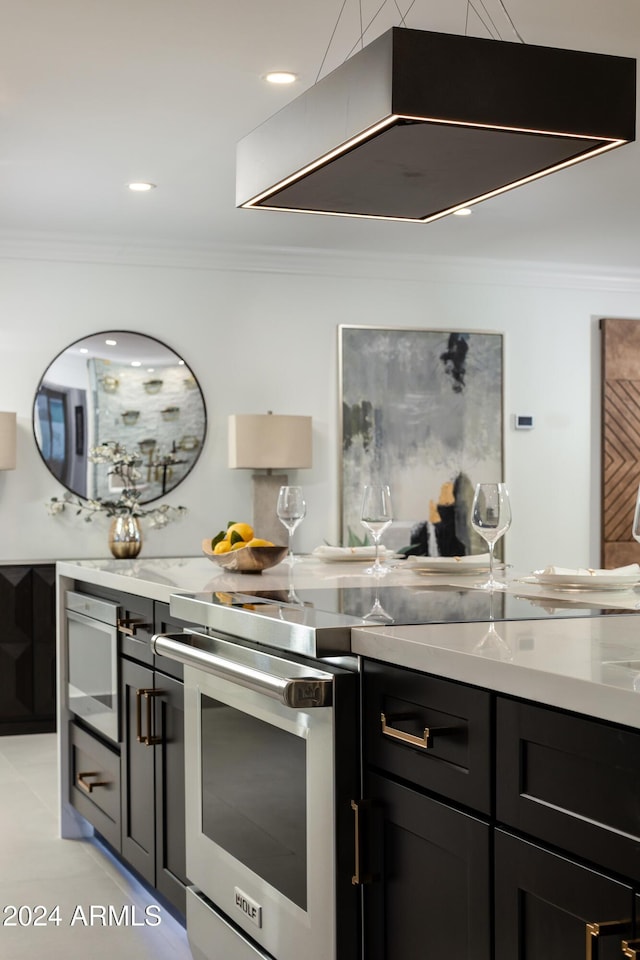 kitchen with light tile patterned floors, ventilation hood, and crown molding