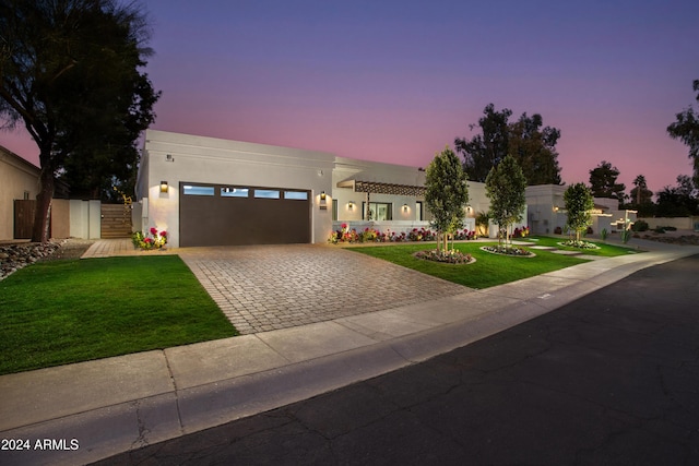 view of front of home featuring a garage and a lawn