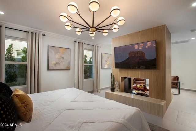 bedroom featuring a multi sided fireplace, an inviting chandelier, crown molding, and light tile patterned flooring