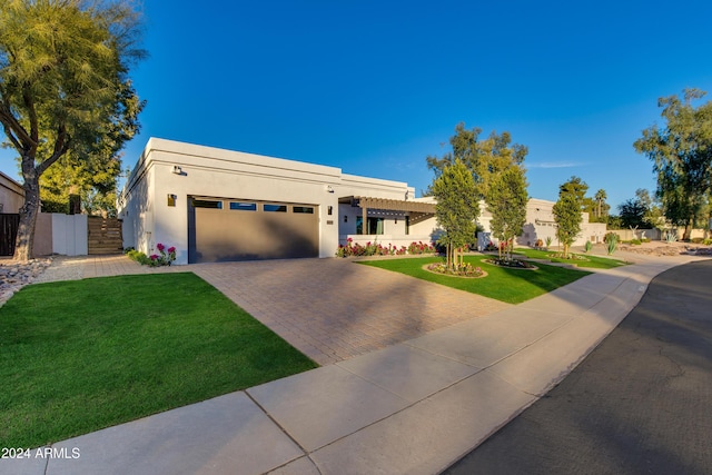 view of front of property featuring a front yard and a garage