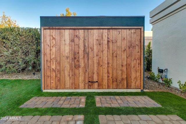 view of outdoor structure featuring a lawn