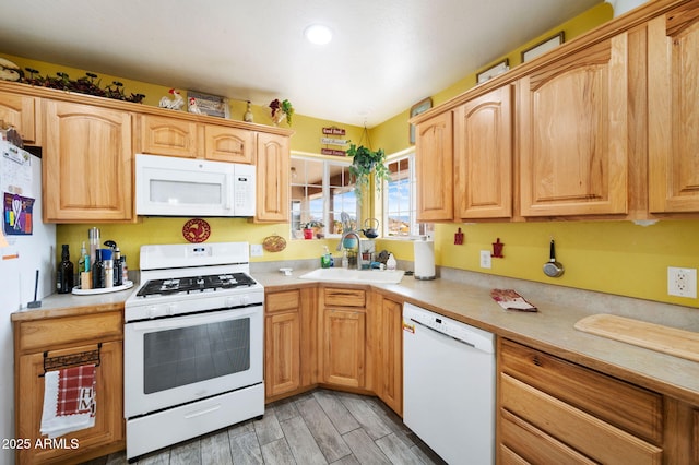 kitchen featuring wood tiled floor, white appliances, light countertops, and a sink